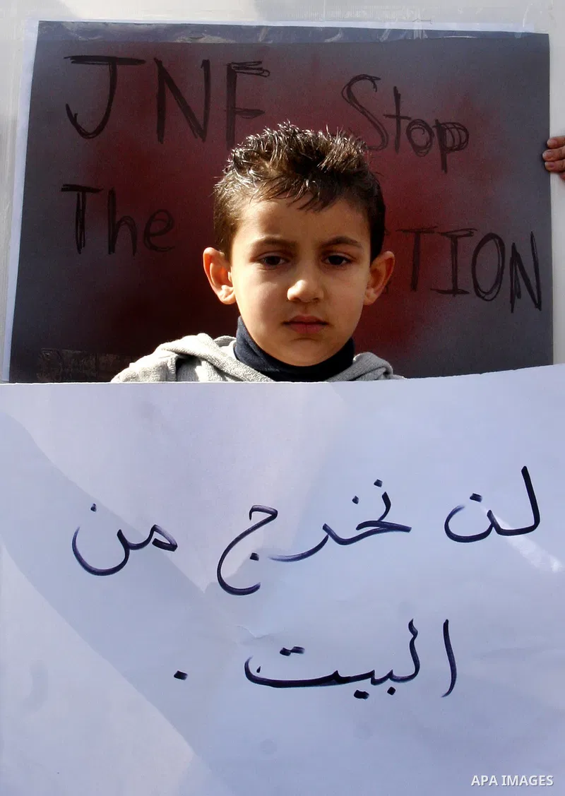 Palestinians and foreigners take part in a protest near the house of Samarin family which the Israeli authorities threatened to size it in Jerusalem's neighbourhood of Silwan on Nov. 25,2011. Photo by Mahfouz Abu Turk
