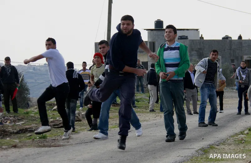 Palestinian protesters clash with Israeli soldiers during a protest near Kufr Qaddum, near the northern West Bank Jewish settlement of Kdumim Friday, Nov. 25, 2011. The protest was held against the closure of a main road...