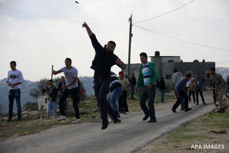 Palestinian protesters clash with Israeli soldiers during a protest near Kufr Qaddum, near the northern West Bank Jewish settlement of Kdumim Friday, Nov. 25, 2011. The protest was held against the closure of a main road...