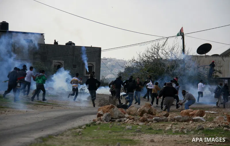 Palestinian protesters clash with Israeli soldiers during a protest near Kufr Qaddum, near the northern West Bank Jewish settlement of Kdumim Friday, Nov. 25, 2011. The protest was held against the closure of a main road...