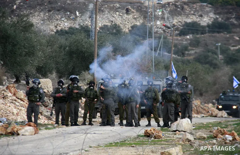 Israeli soldiers clash with Palestinian protesters during a protest near Kufr Qaddum, near the northern West Bank Jewish settlement of Kdumim Friday, Nov. 25, 2011. The protest was held against the closure of a main road...