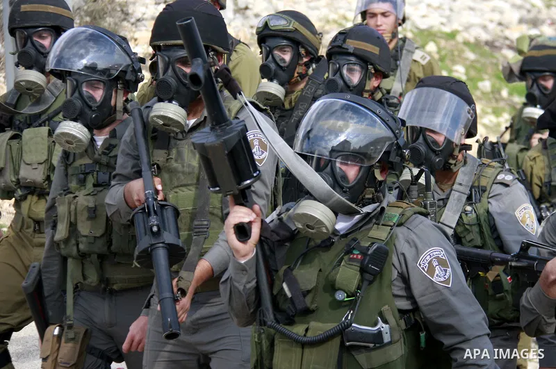 Israeli soldiers clash with Palestinian protesters during a protest near Kufr Qaddum, near the northern West Bank Jewish settlement of Kdumim Friday, Nov. 25, 2011. The protest was held against the closure of a main road...