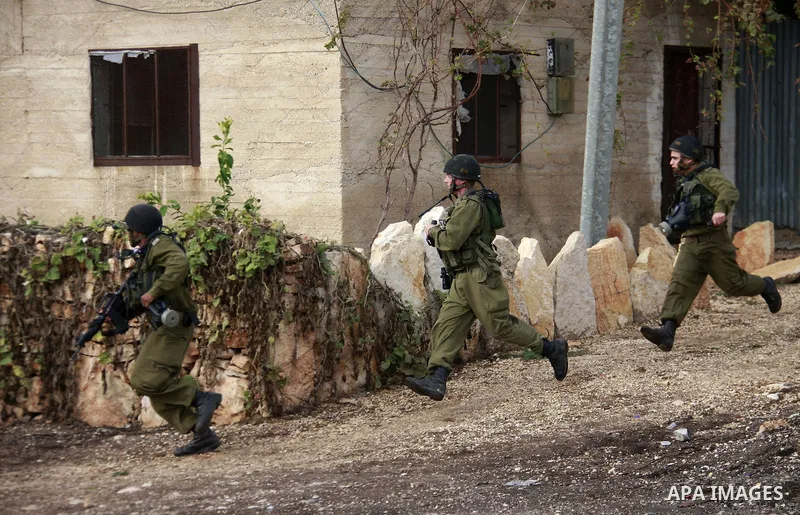 Israeli soldiers clash with Palestinian protesters during a protest near Kufr Qaddum, near the northern West Bank Jewish settlement of Kdumim Friday, Nov. 25, 2011. The protest was held against the closure of a main road...