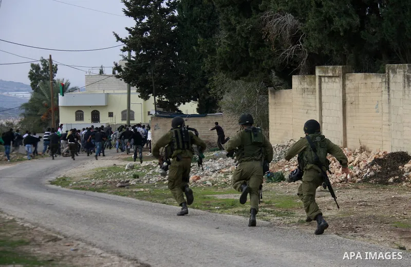 Israeli soldiers clash with Palestinian protesters during a protest near Kufr Qaddum, near the northern West Bank Jewish settlement of Kdumim Friday, Nov. 25, 2011. The protest was held against the closure of a main road...
