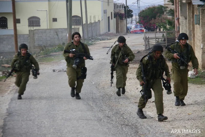 Israeli soldiers clash with Palestinian protesters during a protest near Kufr Qaddum, near the northern West Bank Jewish settlement of Kdumim Friday, Nov. 25, 2011. The protest was held against the closure of a main road...