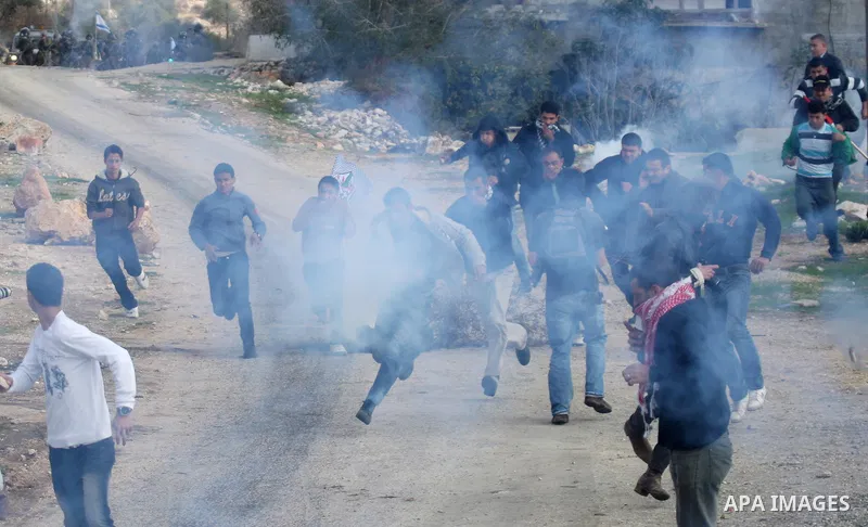 Israeli soldiers clash with Palestinian protesters during a protest near Kufr Qaddum, near the northern West Bank Jewish settlement of Kdumim Friday, Nov. 25, 2011. The protest was held against the closure of a main road...