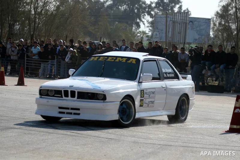 A driver competes with his car during a car rally in the West Bank city of Jericho November 25, 2011. Some 50 drivers from the Palestinian Territories and Jordan competed on Friday in the final round of the Palestinian c...