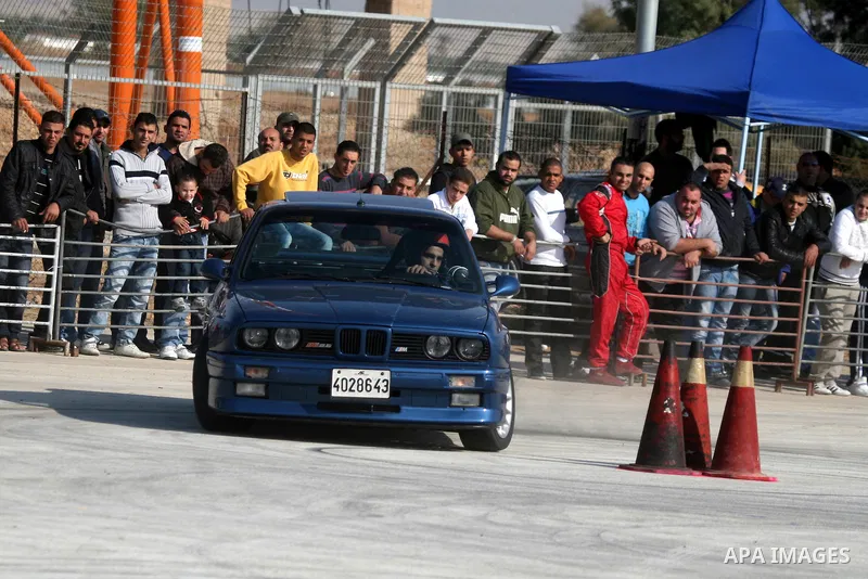 A driver competes with his car during a car rally in the West Bank city of Jericho November 25, 2011. Some 50 drivers from the Palestinian Territories and Jordan competed on Friday in the final round of the Palestinian c...