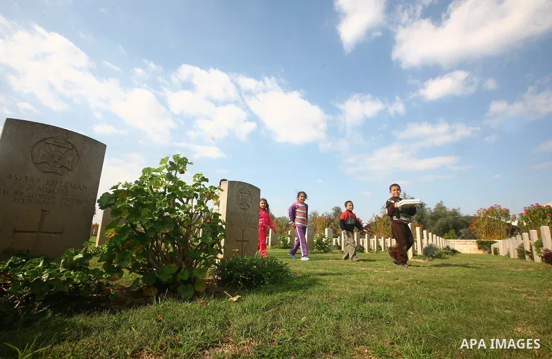 Palestinian children are seen in the British cemetery in Gaza City on Nov 26, 2011. Israel said it would compensate British for damages that hit the British cemetery during the war on Gaza. Photo by Majdi Fathi