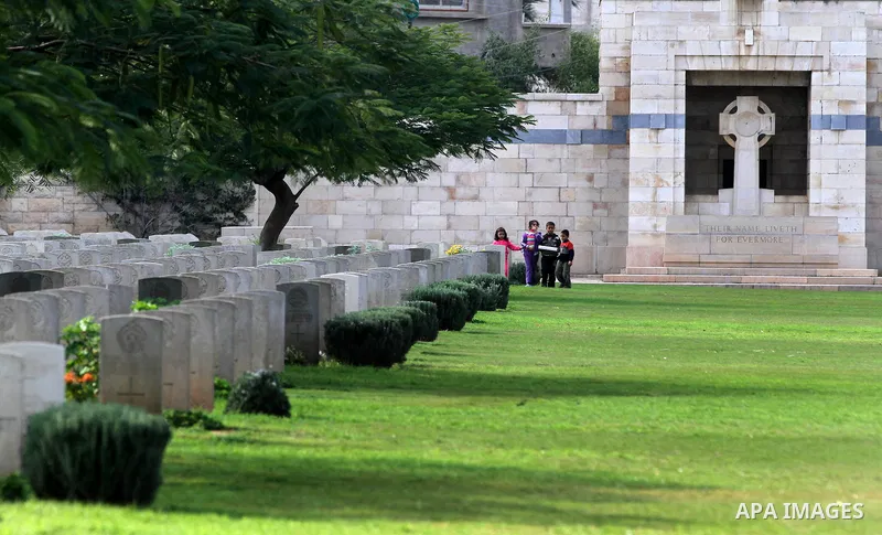 Palestinian children are seen in the British cemetery in Gaza City on Nov 26, 2011. Israel said it would compensate British for damages that hit the British cemetery during the war on Gaza. Photo by Majdi Fathi