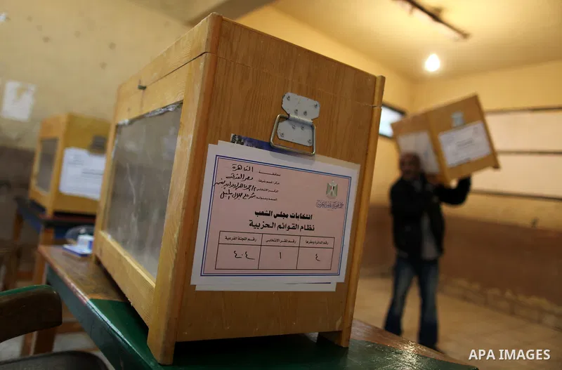An Egyptian man carries an electoral box into a polling station at a school in Cairo on November 27, 2011 on the eve of the first parliament elections since the end of the 30-year rule of strongman Hosni Mubarak. Photo b...