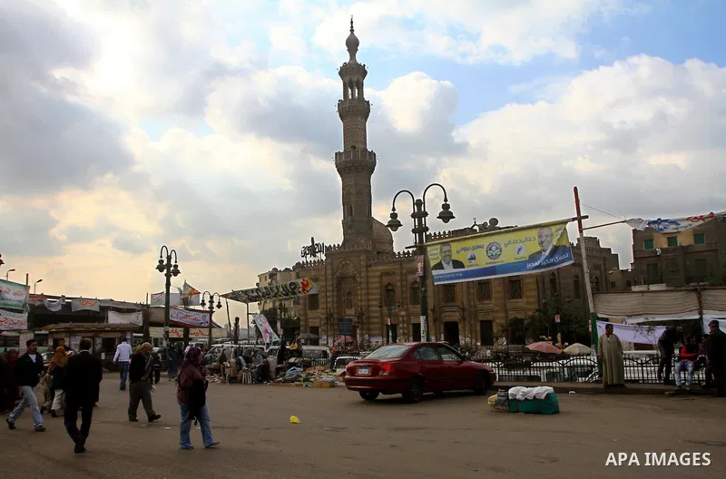 Egyptians walk past electoral campaign posters and banners for candidates in Cairo on November 27, 2011 on the eve of the first parliament elections since the end of the 30-year rule of strongman Hosni Mubarak. Photo by...