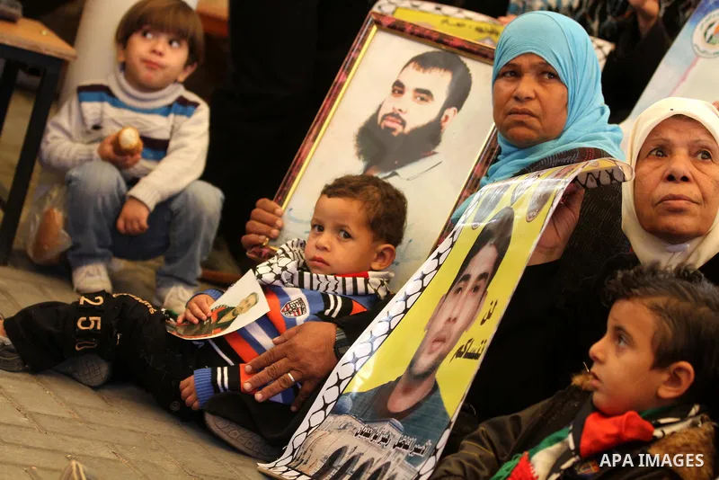 Palestinians gather during a protest at the Red Cross' offices in Gaza City to call for the release of Palestinian prisoners held in Israeli jails, on Nov. 28, 2011. Photo by Mjdi Fathi