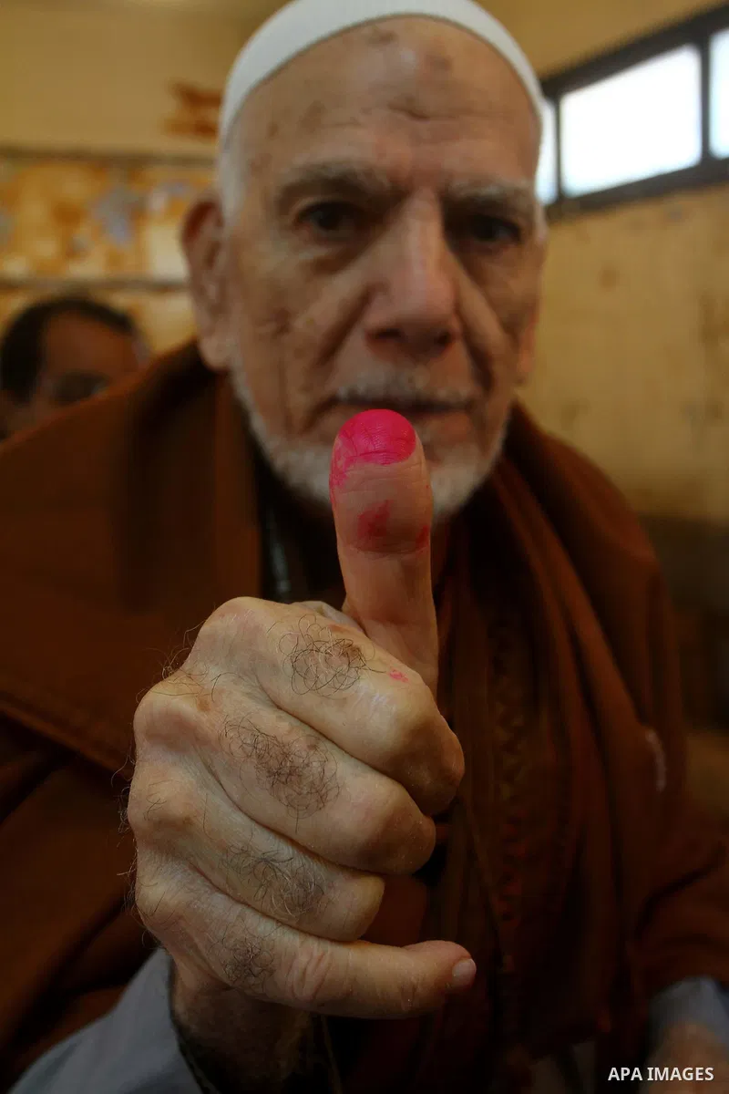 An Egyptian man shows his ink-stained thumb after casting his vote at a polling station in the Manial neighbourhood of Cairo on November 28, 2011. Egyptians began voting in the first elections since the fall of autocrat...
