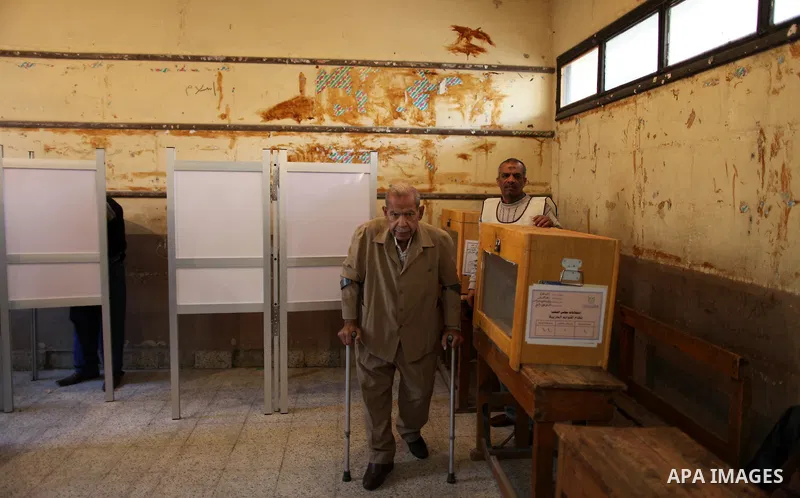 An elderly Egyptian man casts his vote at a polling station in the Manial neighbourhood of Cairo on November 28, 2011. Egyptians began voting in the first elections since the fall of autocrat Hosni Mubarak who was ousted...