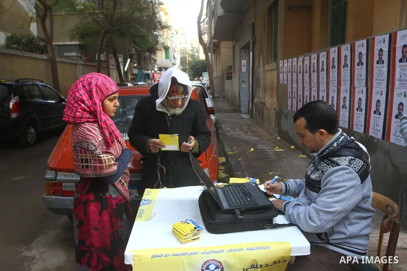 Egyptian voters queue at a polling station in the Manial neighbourhood of Cairo on November 28, 2011. Egyptians began voting in the first elections since the fall of autocrat Hosni Mubarak who was ousted in February in o...