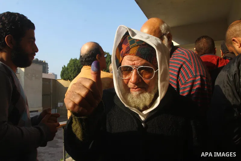 An Egyptian man shows his ink-stained thumb after casting his vote at a polling station in the Manial neighbourhood of Cairo on November 28, 2011. Egyptians began voting in the first elections since the fall of autocrat...