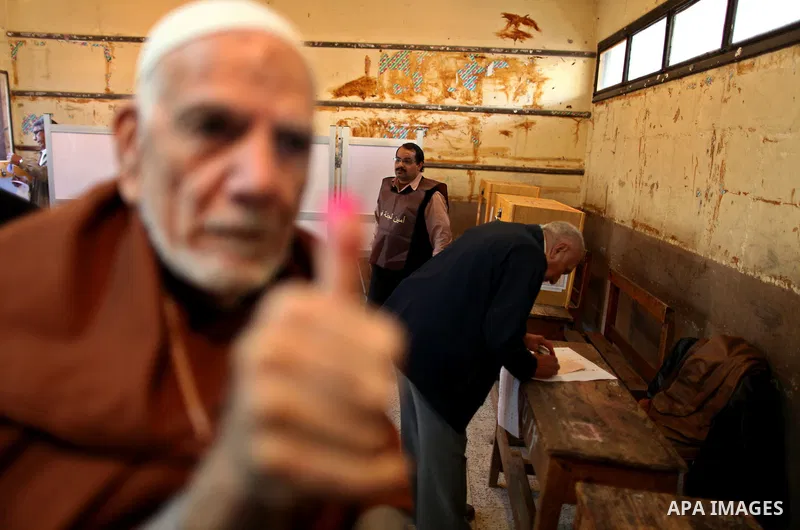 An elderly Egyptian man casts his vote at a polling station in the Manial neighbourhood of Cairo on November 28, 2011. Egyptians began voting in the first elections since the fall of autocrat Hosni Mubarak who was ousted...