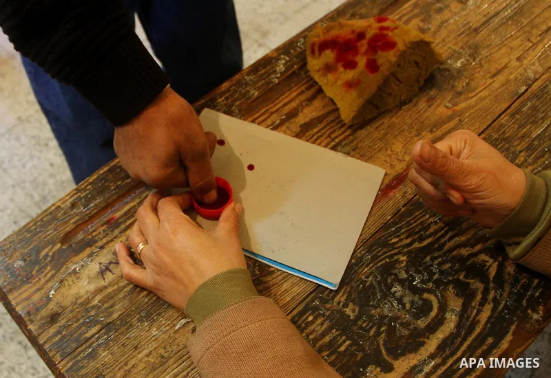 An Egyptian voter dips a finger in a bottle of ink at a polling station in the Manial neighbourhood of Cairo on November 28, 2011. Post-revolution Egypt headed to the polls for a chaotic election clouded by violence and...