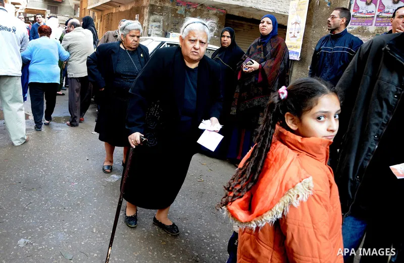An elderly Egyptian woman casts his vote at a polling station in the Manial neighbourhood of Cairo on November 28, 2011. Egyptians began voting in the first elections since the fall of autocrat Hosni Mubarak who was oust...