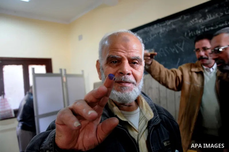 An Egyptian man shows his ink-stained thumb after casting his vote at a polling station in the Manial neighbourhood of Cairo on November 28, 2011. Egyptians began voting in the first elections since the fall of autocrat...