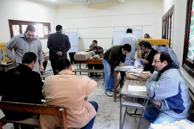 People working in a polling station make preparation for voting in Alexandria, Egypt, Nov. 28, 2011. Egyptians went to the polls on Monday in the first phase of elections for the People's Assembly, the lower house of the...