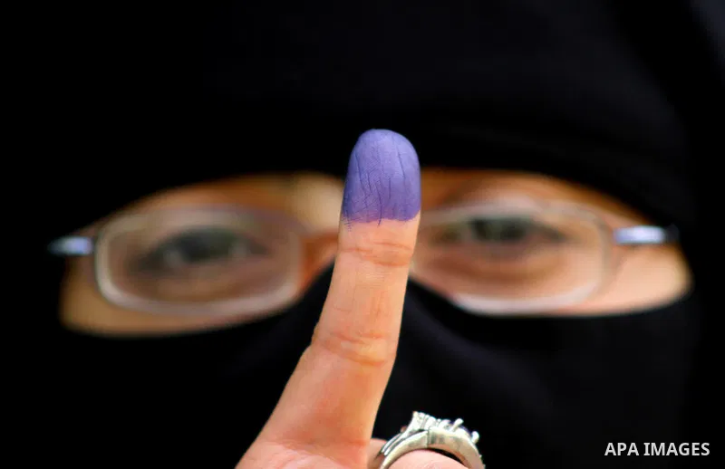 An Egyptian woman shows his ink-stained thumb after casting his vote at a polling station in the Manial neighbourhood of Cairo on November 28, 2011. Egyptians began voting in the first elections since the fall of autocra...
