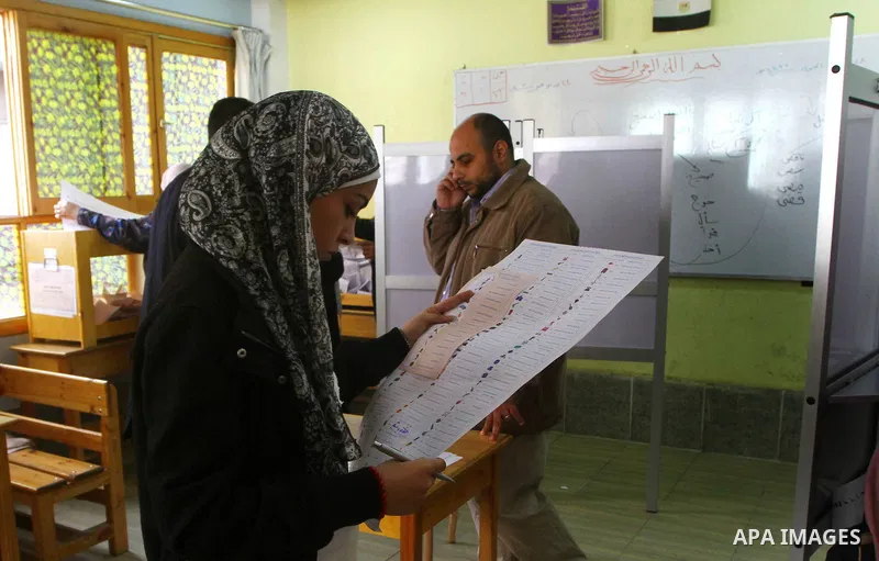 A Egyptian woman casts his vote at a polling station in Cairo on November 28, 2011. Egyptians began voting in the first elections since the fall of autocrat Hosni Mubarak who was ousted in February in one of the most imp...