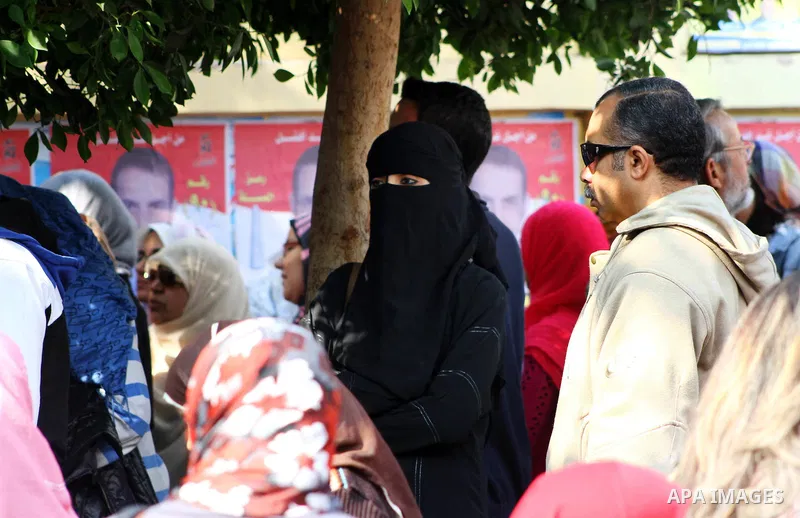Egyptians wait in lines to vote during the first round of Egypt's Parliamentary elections at a polling station in Cairo on November 28, 2011. Egyptians began voting in the first elections since the fall of autocrat Hosni...