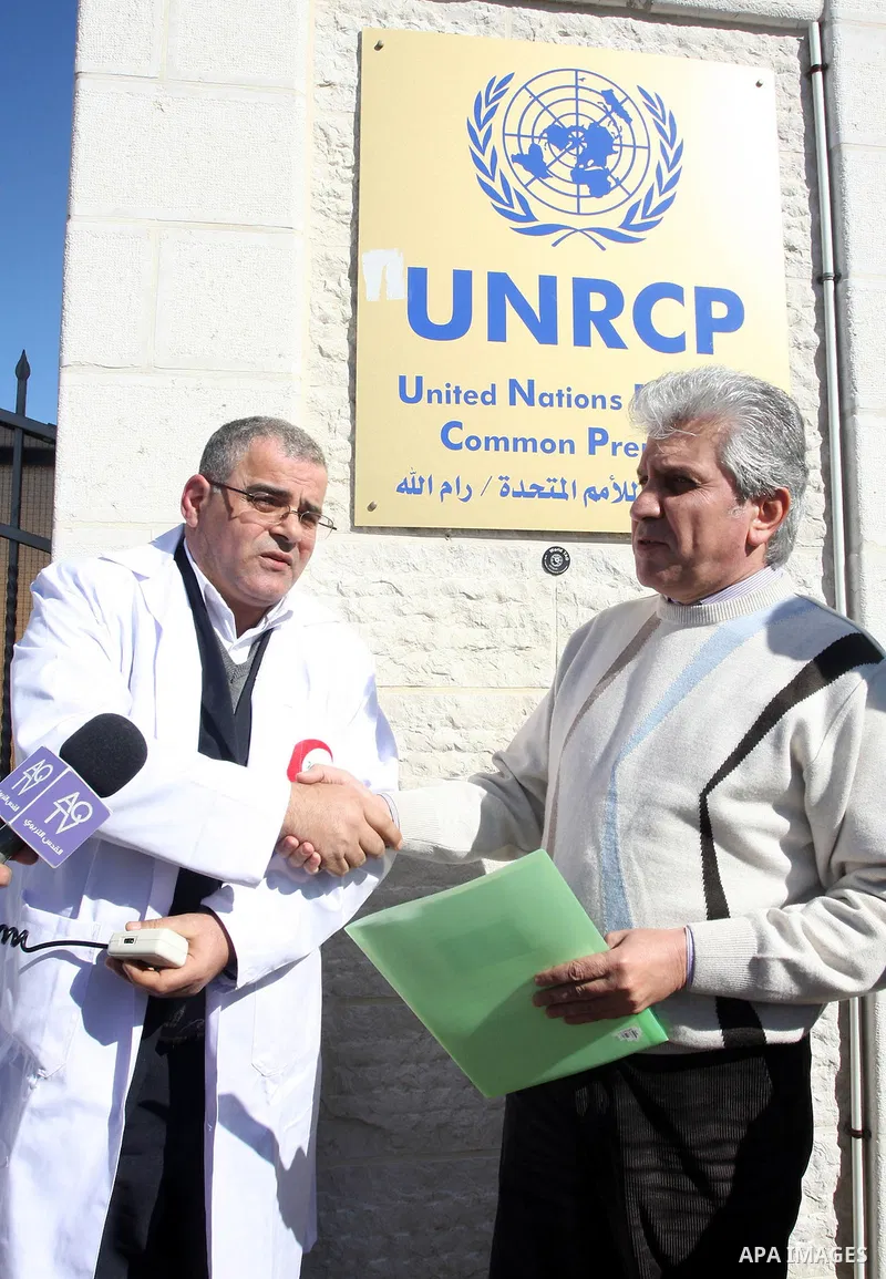 Palestinian doctors hold posters during a protest in front of UN headquarters in Ramallah, West Bank, November 28, 2011 to condemn holding the conference of World Health Organization for Europe, in Israel as the occupyin...