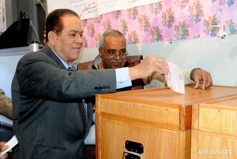Egyptian Premier Kamal al-Ganzuri casts his ballot at a polling station in Cairo's Heliopolis district on November 28, 2011 as Egyptians flocked to the polls for a first post-revolution election, making a mostly orderly...
