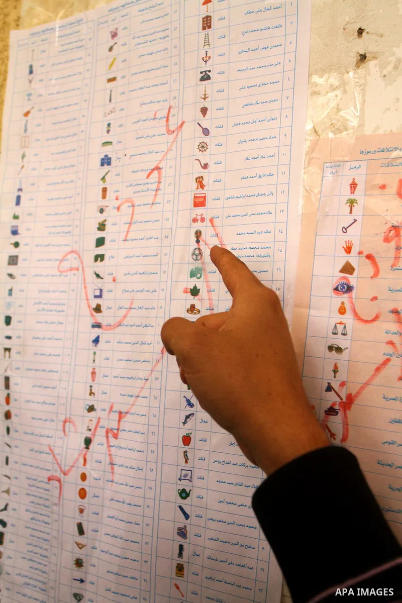 A Egyptian man casts his vote at a polling station in the Manial neighbourhood of Cairo on November 28, 2011. Egyptians began voting in the first elections since the fall of autocrat Hosni Mubarak who was ousted in Febru...