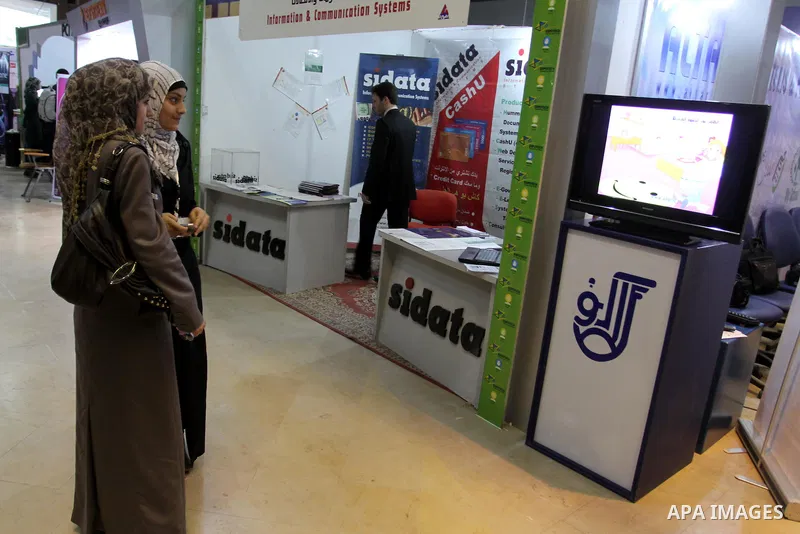 Palestinians attend to the Expotech exhibition for telecom and information technology , in Gaza City on Nov. 29, 2011. Photo by Mohammed Asad