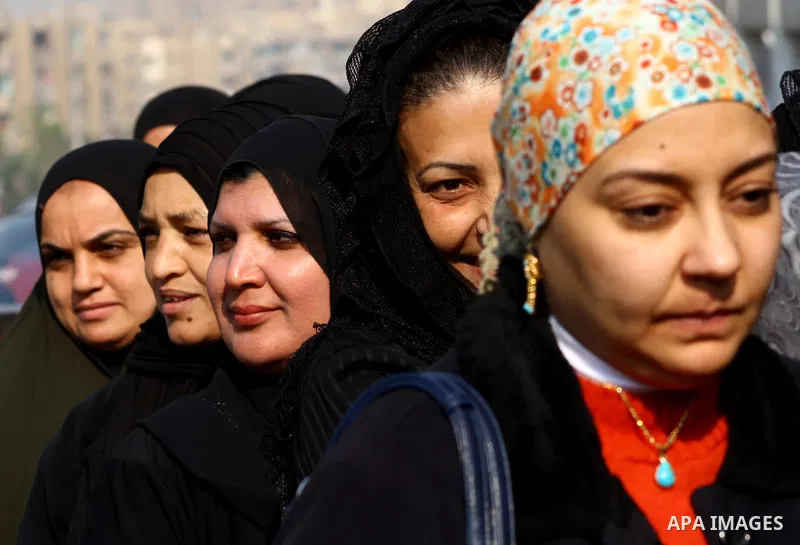 Egyptians wait in line to vote at a polling station in the Moqattam district of Cairo on November 29, 2011. Egypt hailed the start of its first post-revolution election as a triumph for democracy as more voters headed to...