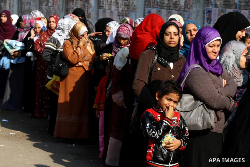 Egyptians wait in line to vote at a polling station in the Moqattam district of Cairo on November 29, 2011. Egypt hailed the start of its first post-revolution election as a triumph for democracy as more voters headed to...