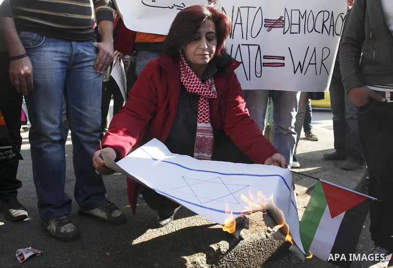 Palestinian and foreign peace activists hold placards during a gathering to mark the International Day of Solidarity with the Palestinian People, on November 29, 2011 in the West Bank city of Nablus. Photo by Wagdi Eshta...