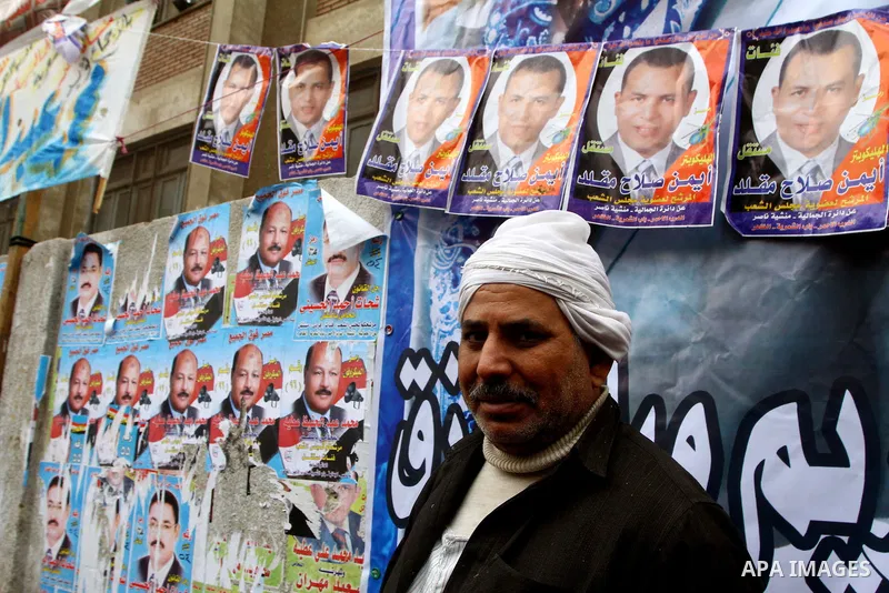 An Egyptian man walks outside a polling station in the Moqattam district of Cairo on November 29, 2011. Egypt hailed the start of its first post-revolution election as a triumph for democracy as more voters headed to the...