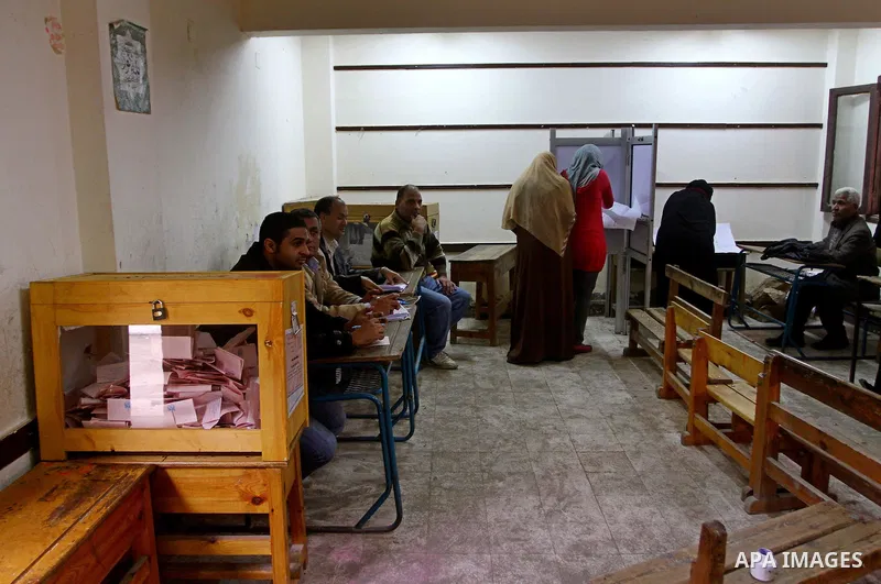 Egyptians cast their ballot at a parliamentary polling station in Cairo on November 29, 2011. Egypt hailed the start of its first post-revolution election as a triumph for democracy as more voters headed to the polls, bo...