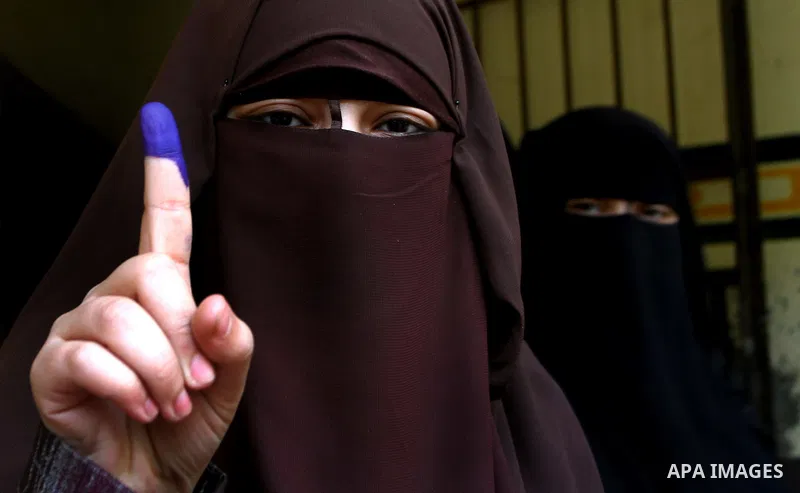Egyptians cast their ballot at a parliamentary polling station in Cairo on November 29, 2011. Egypt hailed the start of its first post-revolution election as a triumph for democracy as more voters headed to the polls, bo...