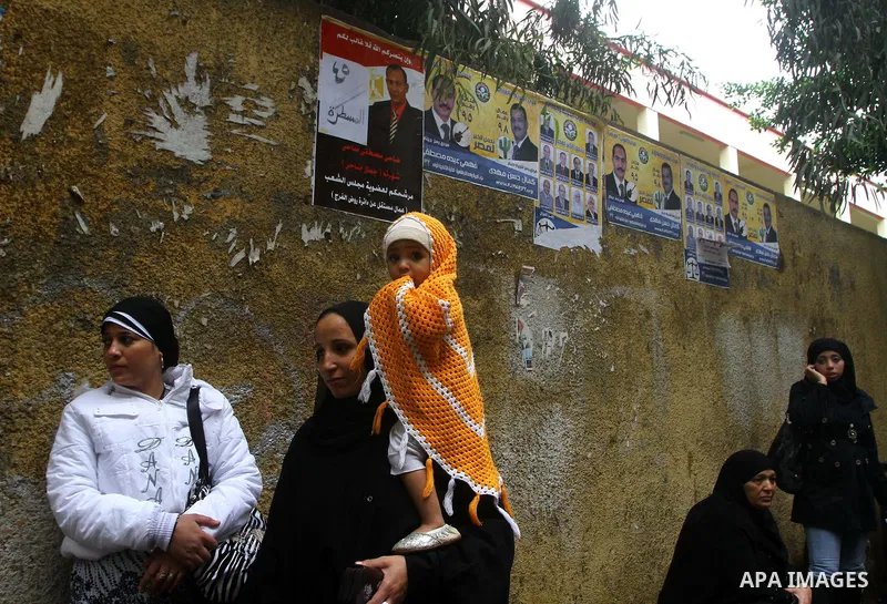 Egyptians cast their ballot at a parliamentary polling station in Cairo on November 29, 2011. Egypt hailed the start of its first post-revolution election as a triumph for democracy as more voters headed to the polls, bo...