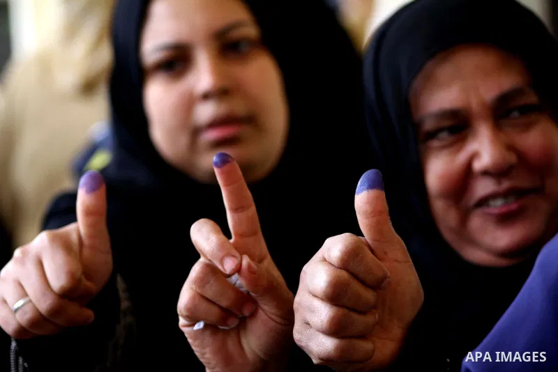 Egyptians cast their ballot at a parliamentary polling station in Cairo on November 29, 2011. Egypt hailed the start of its first post-revolution election as a triumph for democracy as more voters headed to the polls, bo...