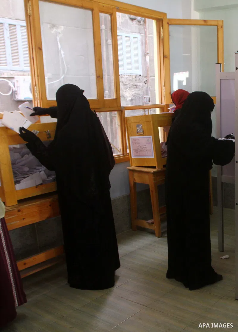 Egyptians cast their ballot at a parliamentary polling station in Cairo on November 29, 2011. Egypt hailed the start of its first post-revolution election as a triumph for democracy as more voters headed to the polls, bo...