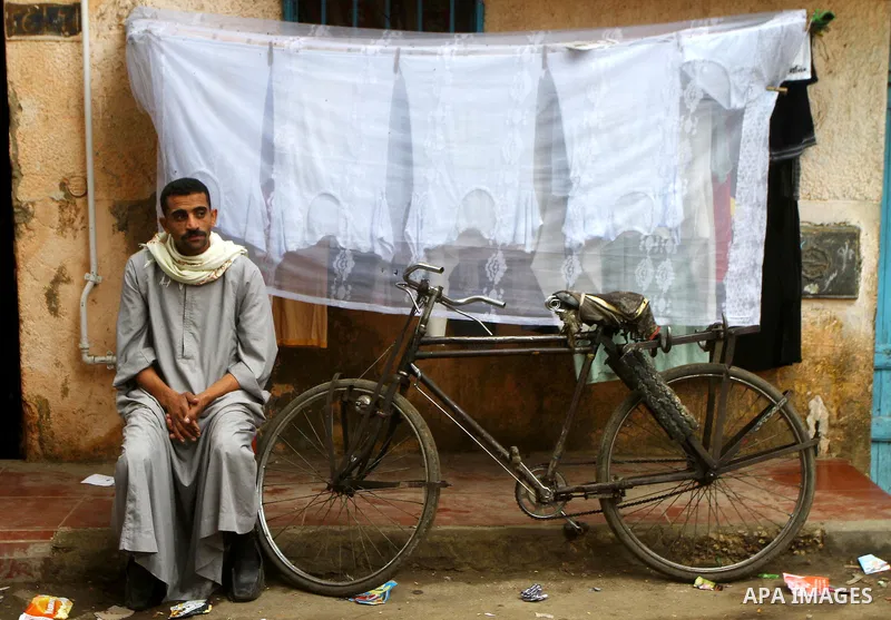 An Egyptian man sits outside his house in Cairo on November 29, 2011. Egypt hailed the start of its first post-revolution election as a triumph for democracy as more voters headed to the polls, boosting turn-out for a vo...