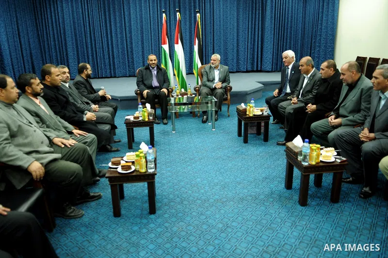 Palestinian prime minister in Gaza Strip, Ismail haniya attends a meeting with members of al-Shatea Services Sport Club at his office, in Gaza city on Nov. 30,2011. Photo by Ahmed Shaat