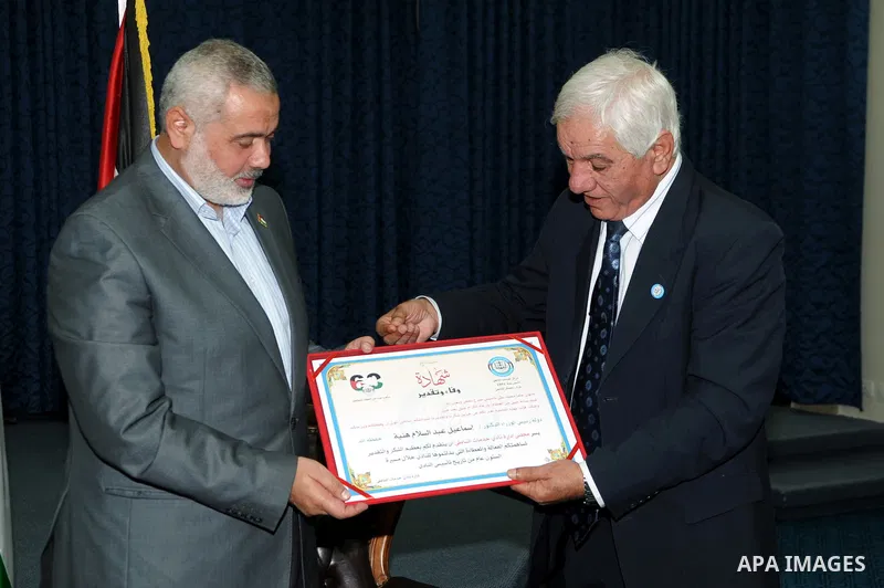 Palestinian prime minister in Gaza Strip, Ismail haniya attends a meeting with members of al-Shatea Services Sport Club at his office, in Gaza city on Nov. 30,2011. Photo by Ahmed Shaat