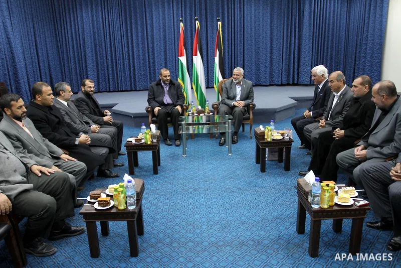 Palestinian prime minister in Gaza Strip, Ismail haniya attends a meeting with members of al-Shatea Services Sport Club at his office, in Gaza city on Nov. 30,2011. Photo by Mohammed Asad