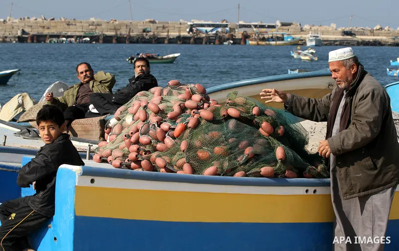 Palestinian fishermen work at the port in Gaza City on December 01, 2011. Before the Israeli embargo on the Palestinian territory, some 3,500 fishermen plied their trade off Gaza's 40-kilometre (25-mile) Mediterranean co...