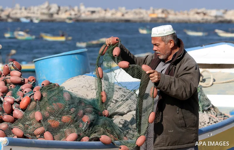 A Palestinian fisherman works at the port in Gaza City on December 01, 2011. Before the Israeli embargo on the Palestinian territory, some 3,500 fishermen plied their trade off Gaza's 40-kilometre (25-mile) Mediterranean...