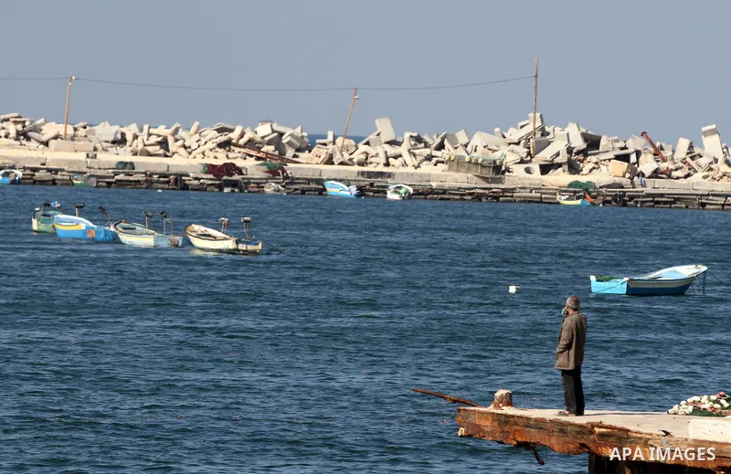 A Palestinian fisherman works at the port in Gaza City on December 01, 2011. Before the Israeli embargo on the Palestinian territory, some 3,500 fishermen plied their trade off Gaza's 40-kilometre (25-mile) Mediterranean...