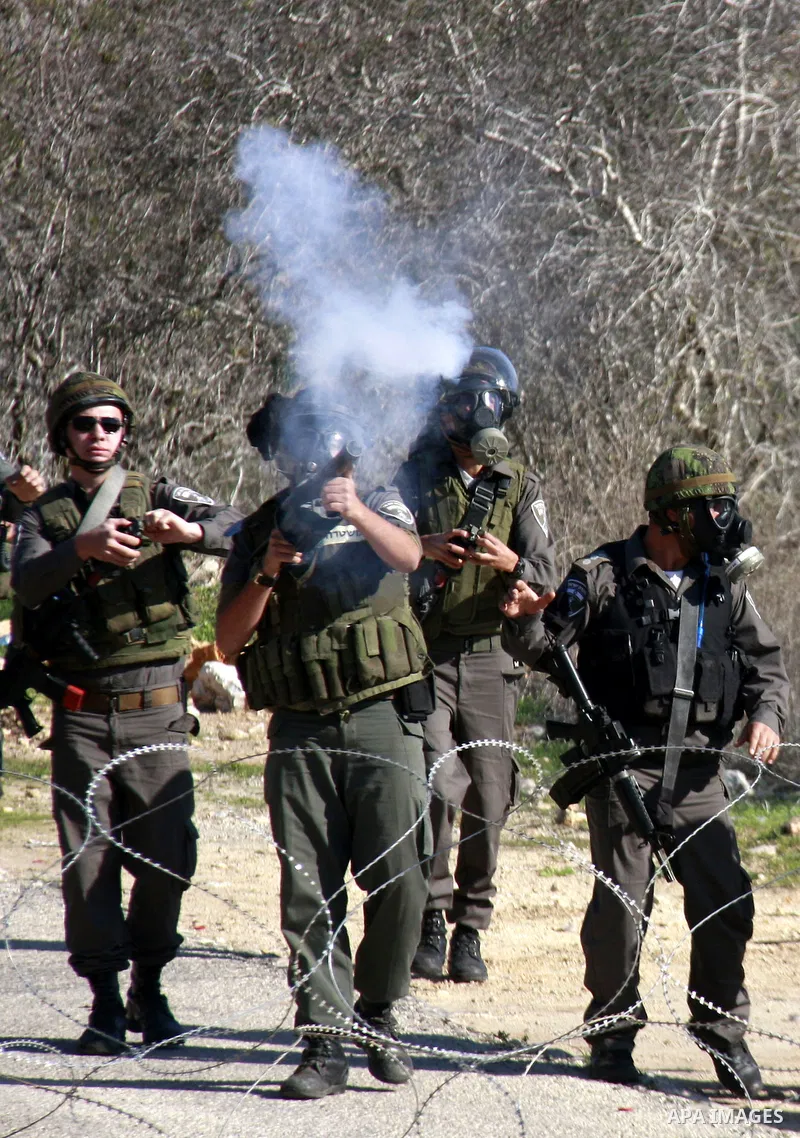 Israeli border police officers fire tear gas towards Palestinian demonstrators, not seen, during a protest in the village of Kufr Qaddum near the Israeli settlement of Kdumim, in the northern West Bank, Friday, Dec. 2, 2...